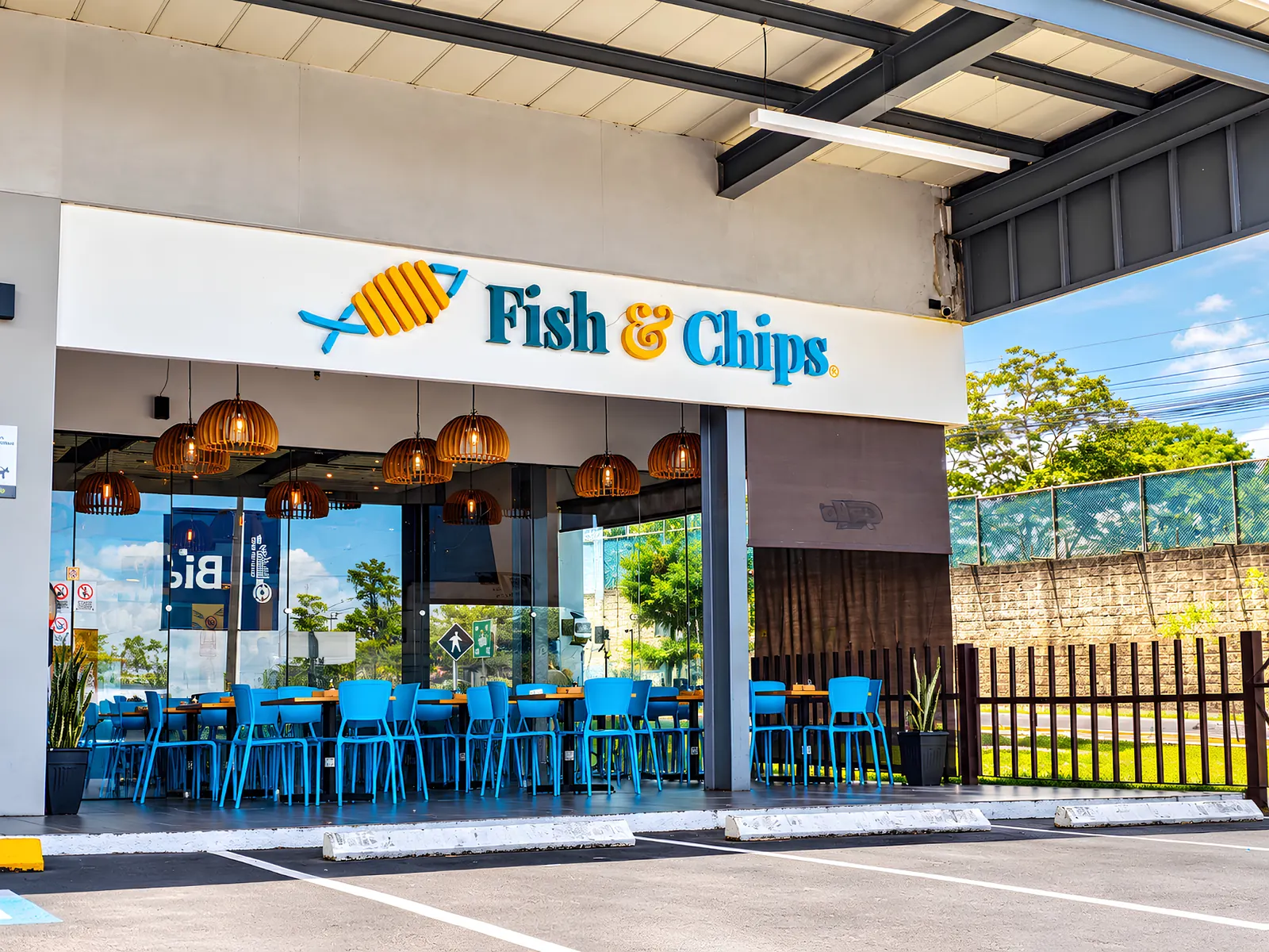Fachada del local Fish & Chips en Centro San Isidro, Zona 16, con terraza y sillas azules